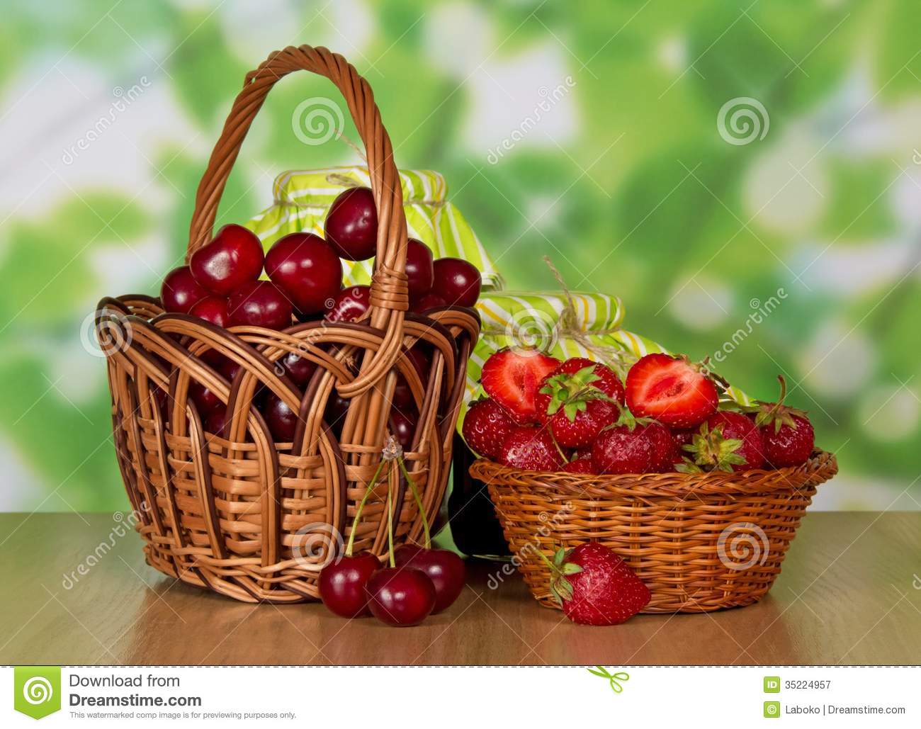     Basket With Sweet Cherries And A Basket With Strawberry On A Table