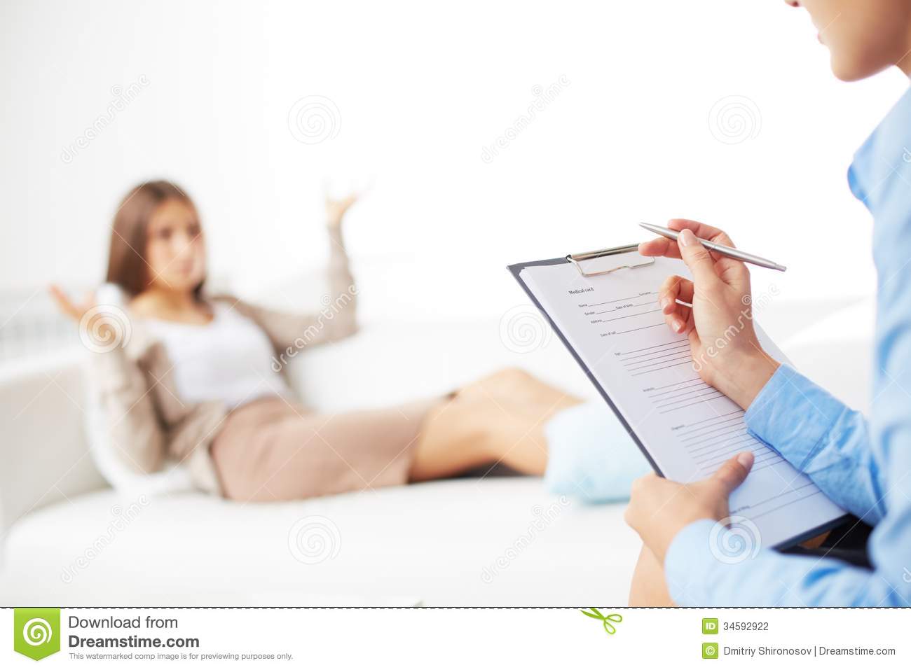 Consulting Her Patient And Making Notes In Application Form