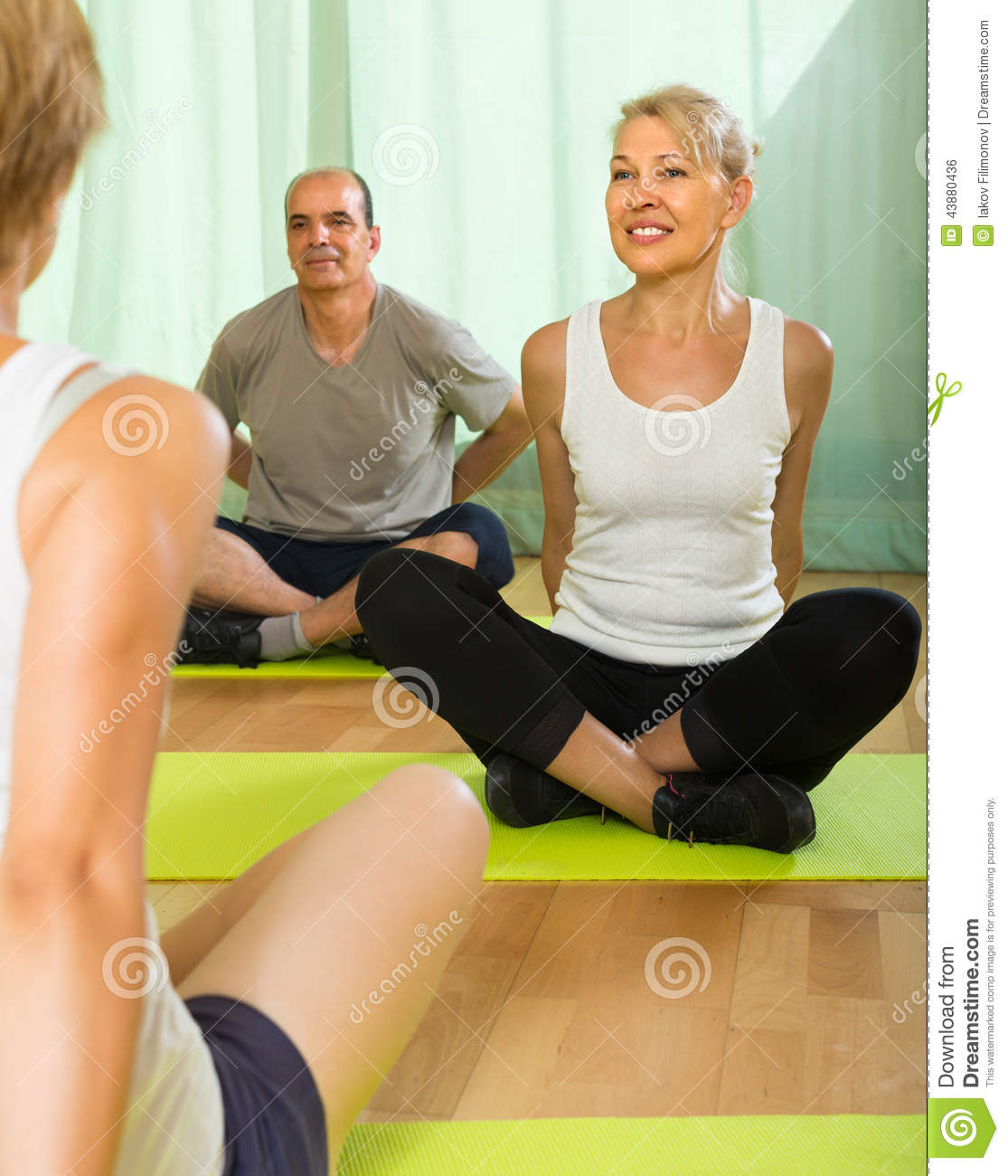 Mature Couple Practicing Yoga With Instructor Stock Photo   Image