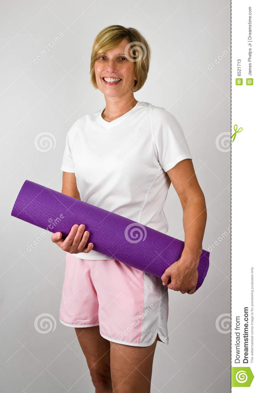 Physically Fit Senior Baby Boomer Women With Yoga Polaties Mat