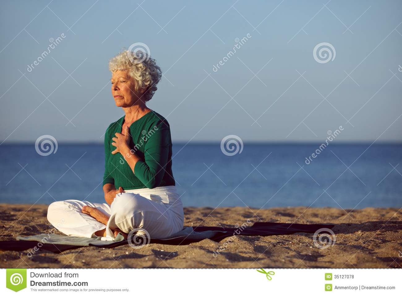 Senior Woman In Meditation By Beautiful Ocean  Eldery Woman Doing Yoga