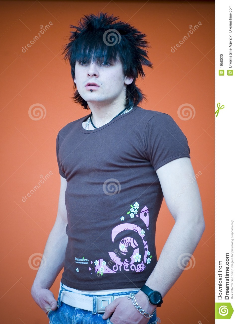 Young Man With Dreamstime Shirt And Spiky Hair Standing With Hands In    