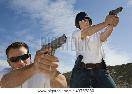 Man And Woman Aiming Hand Guns At Firing Range Stock Photo   Stock    