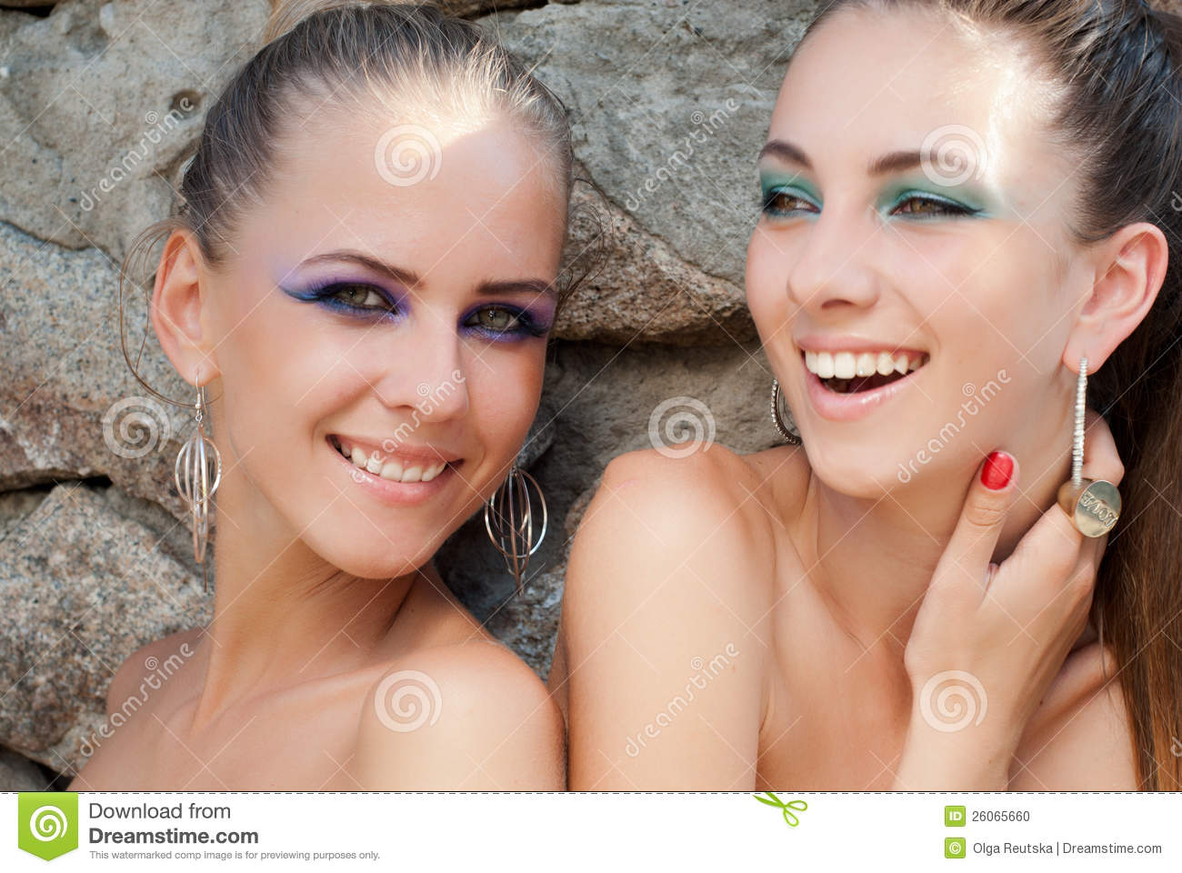 Two Happy Laughing Fashion Models With Bright Makeup On The Granite    