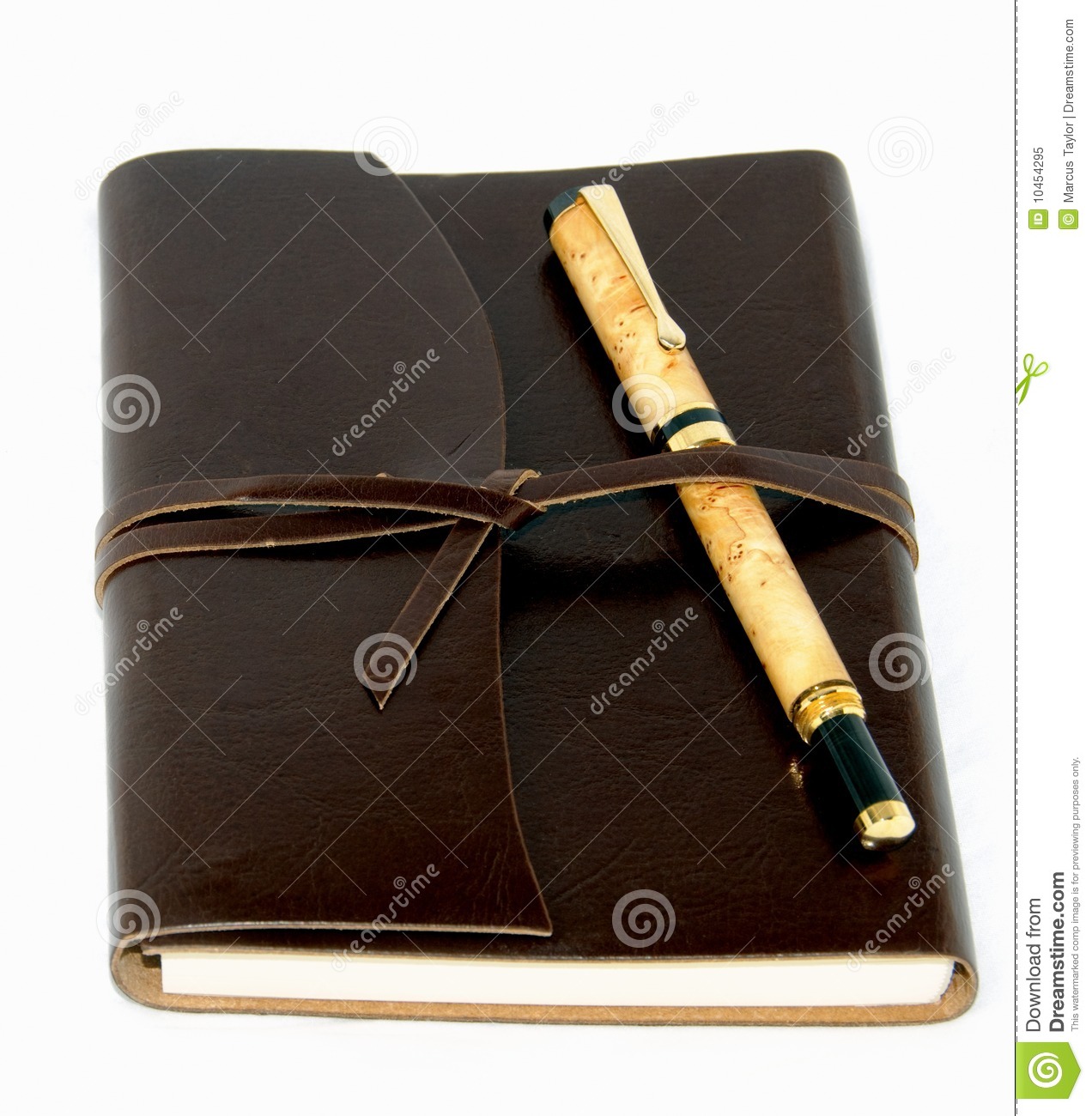 Leather Bound Journal With A Fancy Wood And Gold Pen On A White