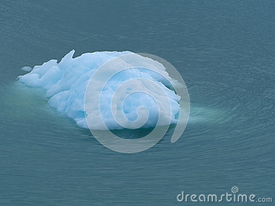 Turquoise Iceberg Floating Drifting On Sea During The Spring Summer