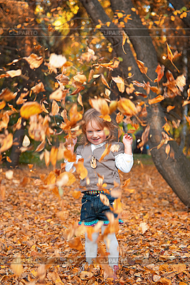 Little Girl Playing With Autumn Leaves   High Resolution Stock Photo    