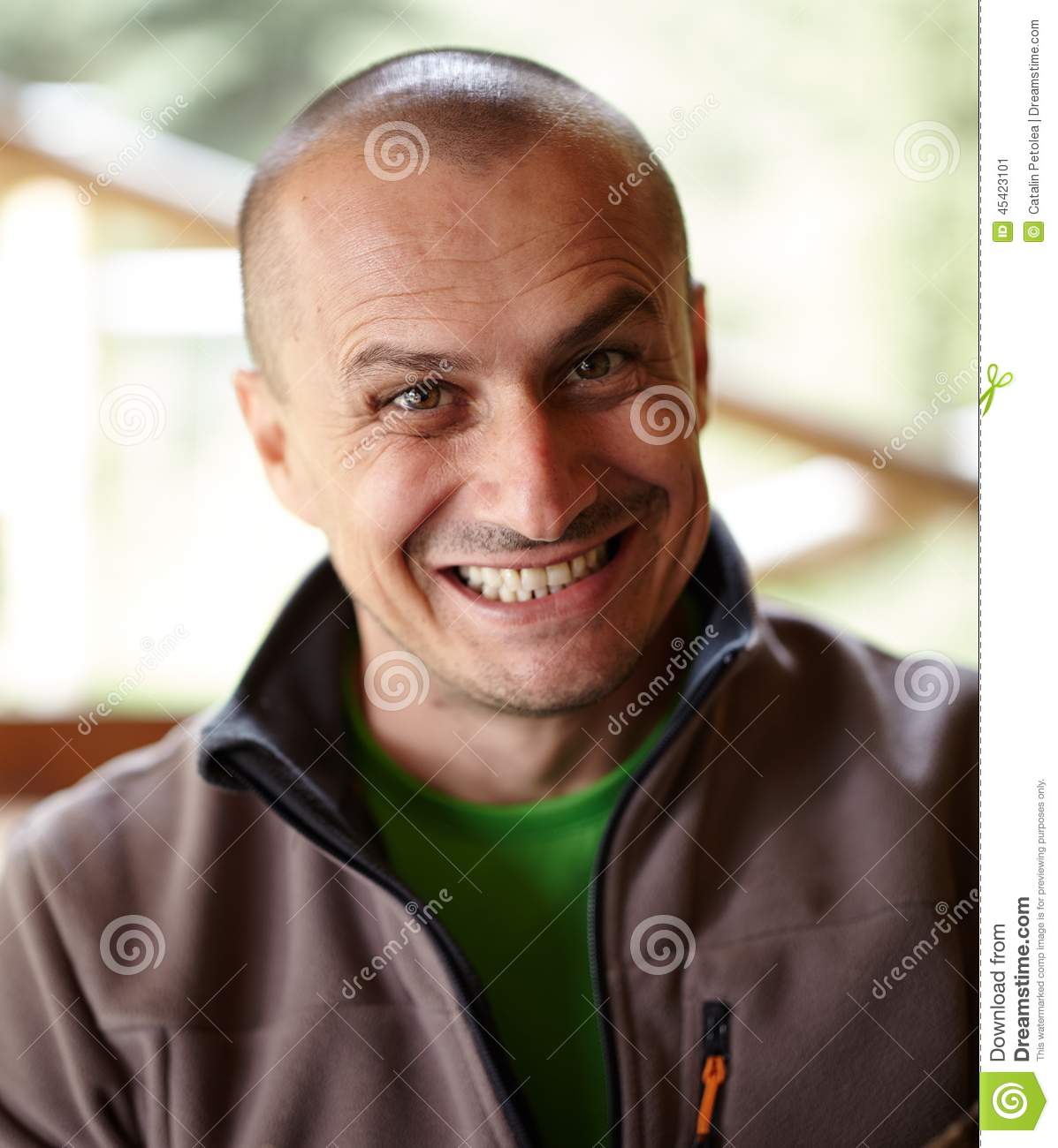 Closeup Of A Caucasian Man Outdoor With A Funny Grin