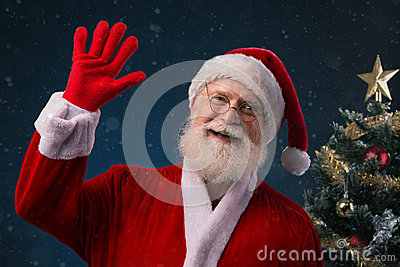 Smiling Santa Claus Saying Hello And Waving With His Hand