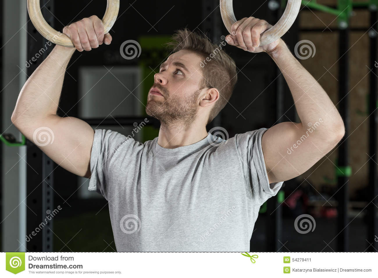 Close Up Of Handsome Muscular Man And Gymnastic Circles