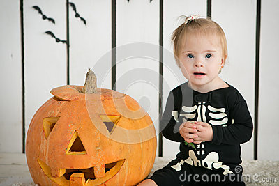 Stock Photo  Eautiful Little Girl With Down Syndrome Sitting Near A    