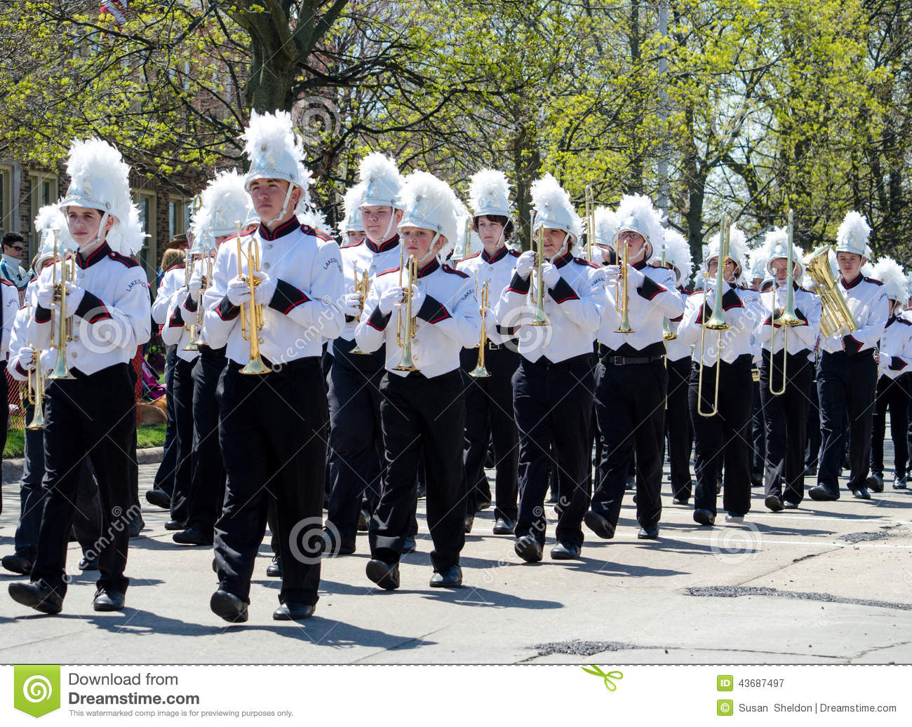 High School Students In Uniform Cary Wind Instruments And March During