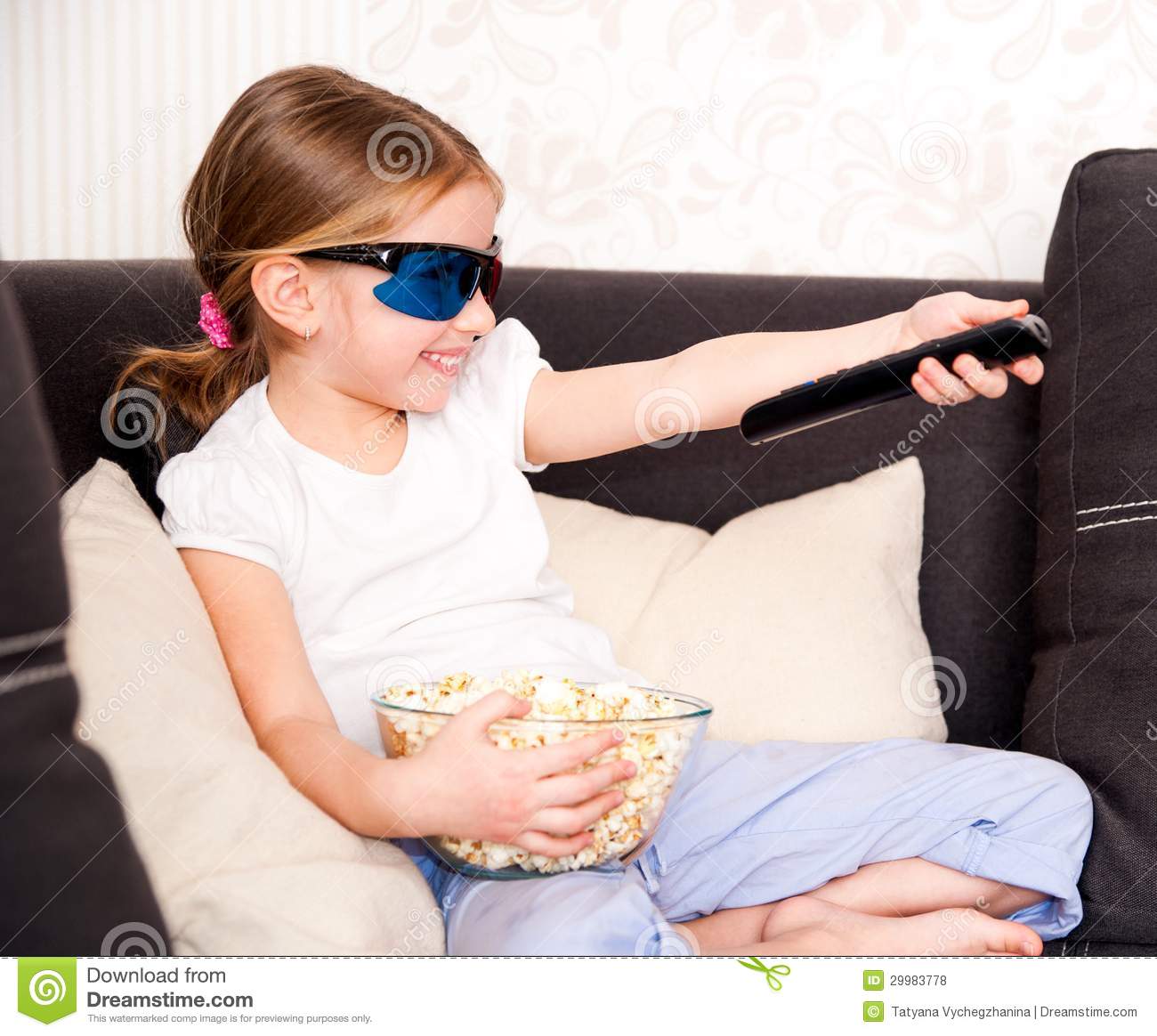Little Girl With Popcorn In 3d Glasses Holding A Remote Control