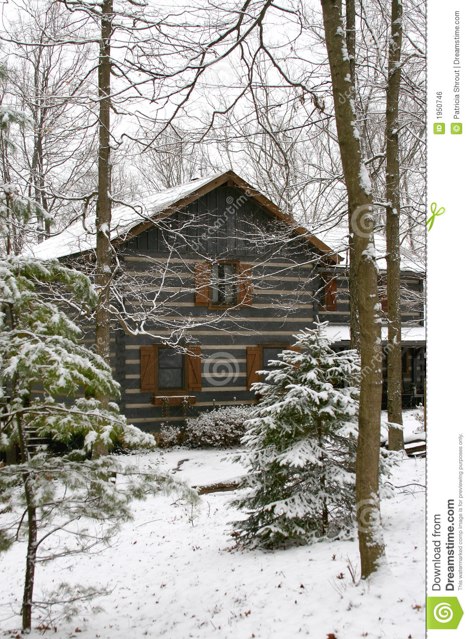 Log Cabin In A Snow Covered Wooded Area