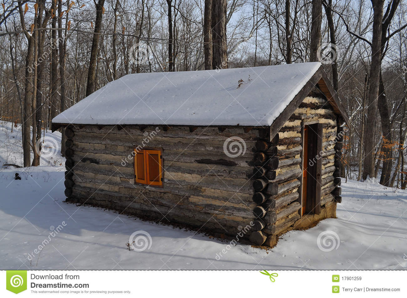 Scenic View Of Snow Covered Log Cabin In Winter With Wood Or Forest In