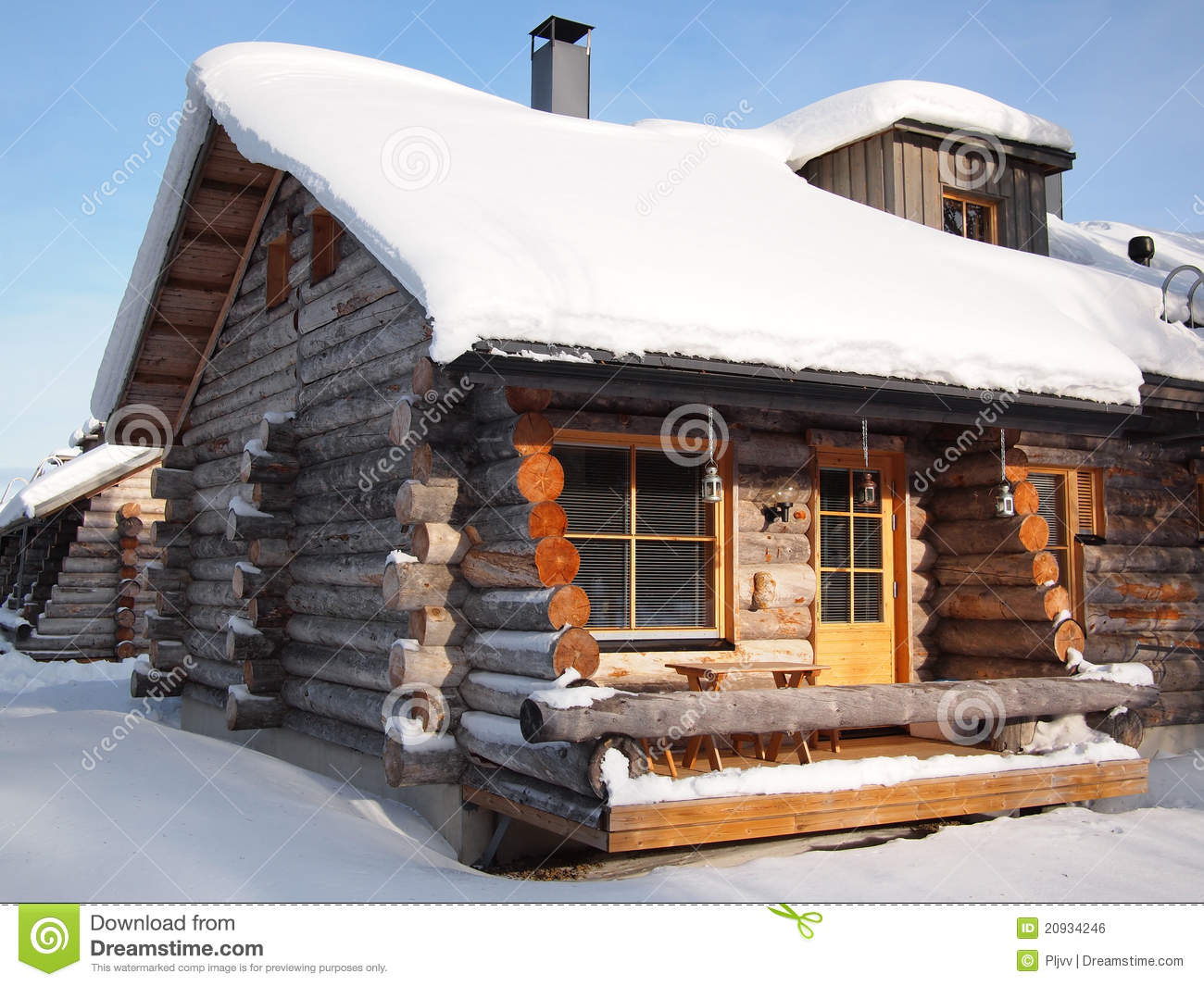 Traditional Snow Covered Log Cabin In A Holiday Resort In Lapland
