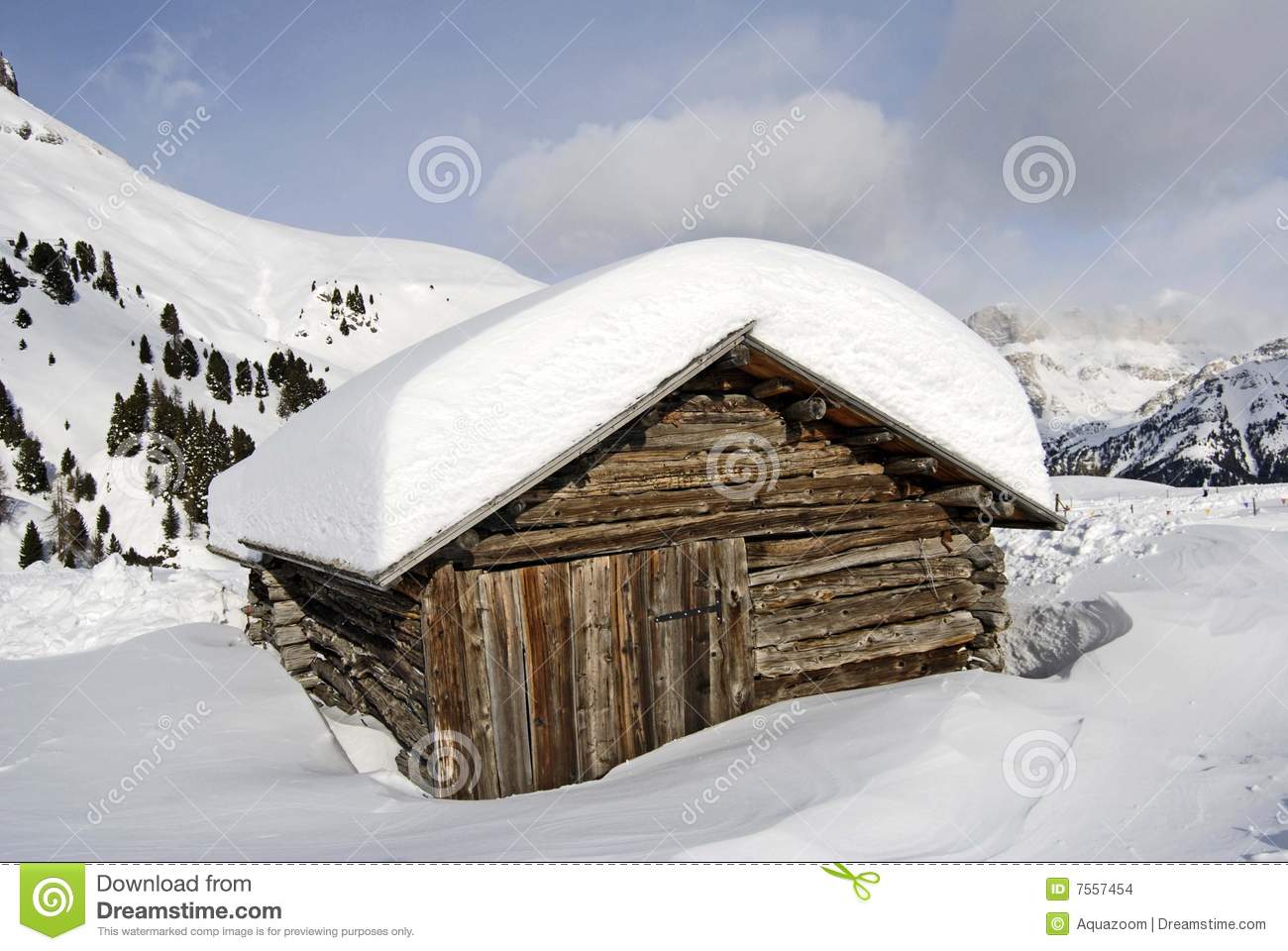 View Of A Small Snow Covered Cabin Or Log Building High In The