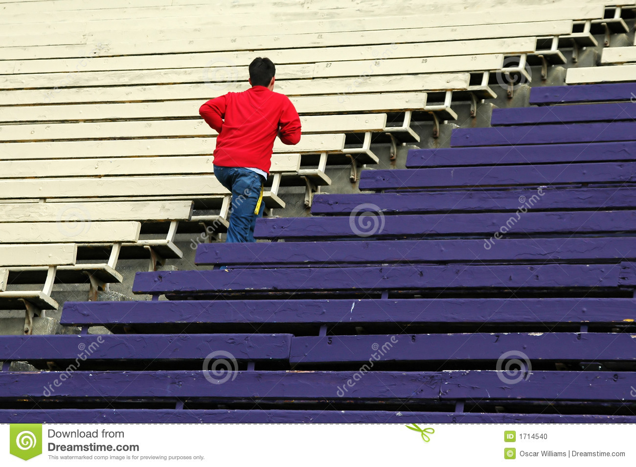 Teen Running Up Some Bleachers In A Stadium