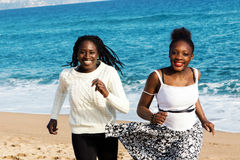 Two African Teen Girls Running On Beach  Stock Images