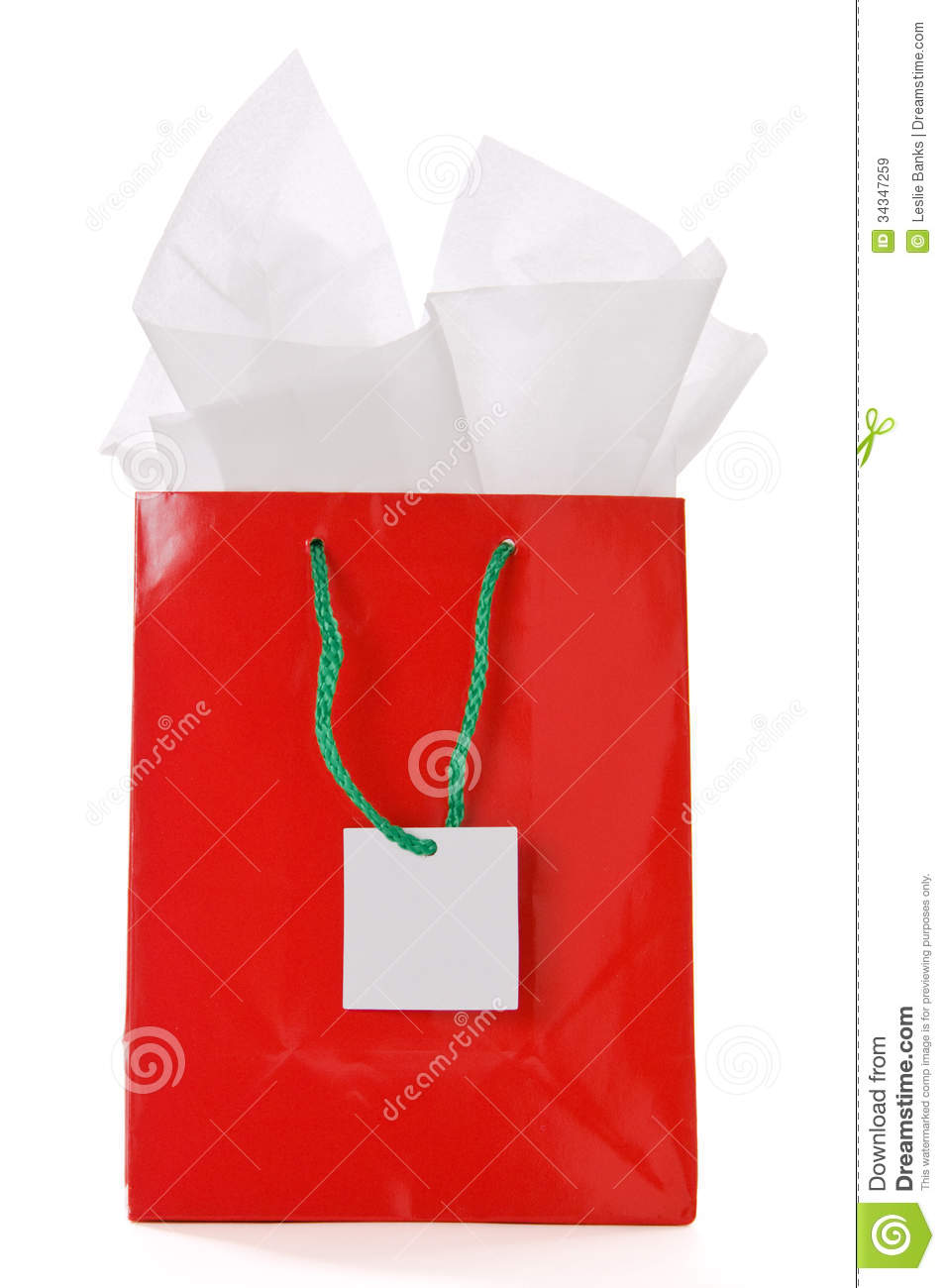 Red Christmas Gift Bag With Tissue Paper And Blank White Card Isolated