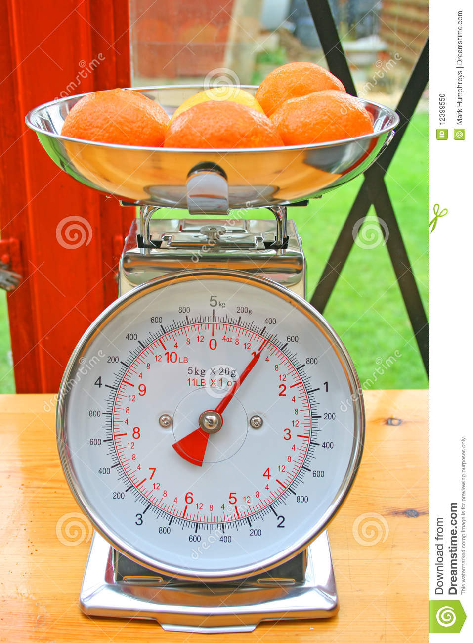 Kitchen Scales With Oranges And A Lemon In The Weighing Bowl On A