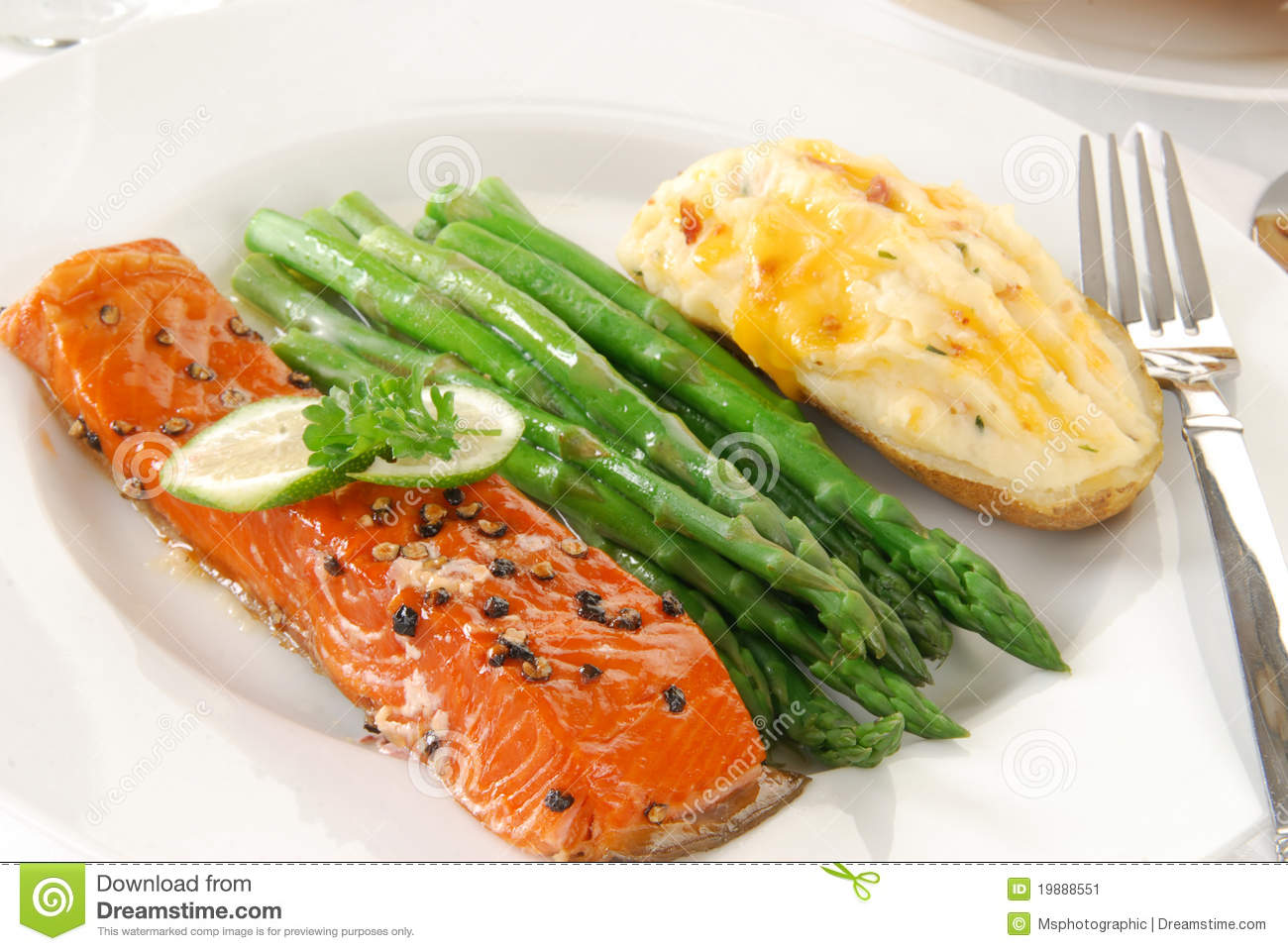 An Elegant Dinner Of Salmon Asparagus And Baked Potato 