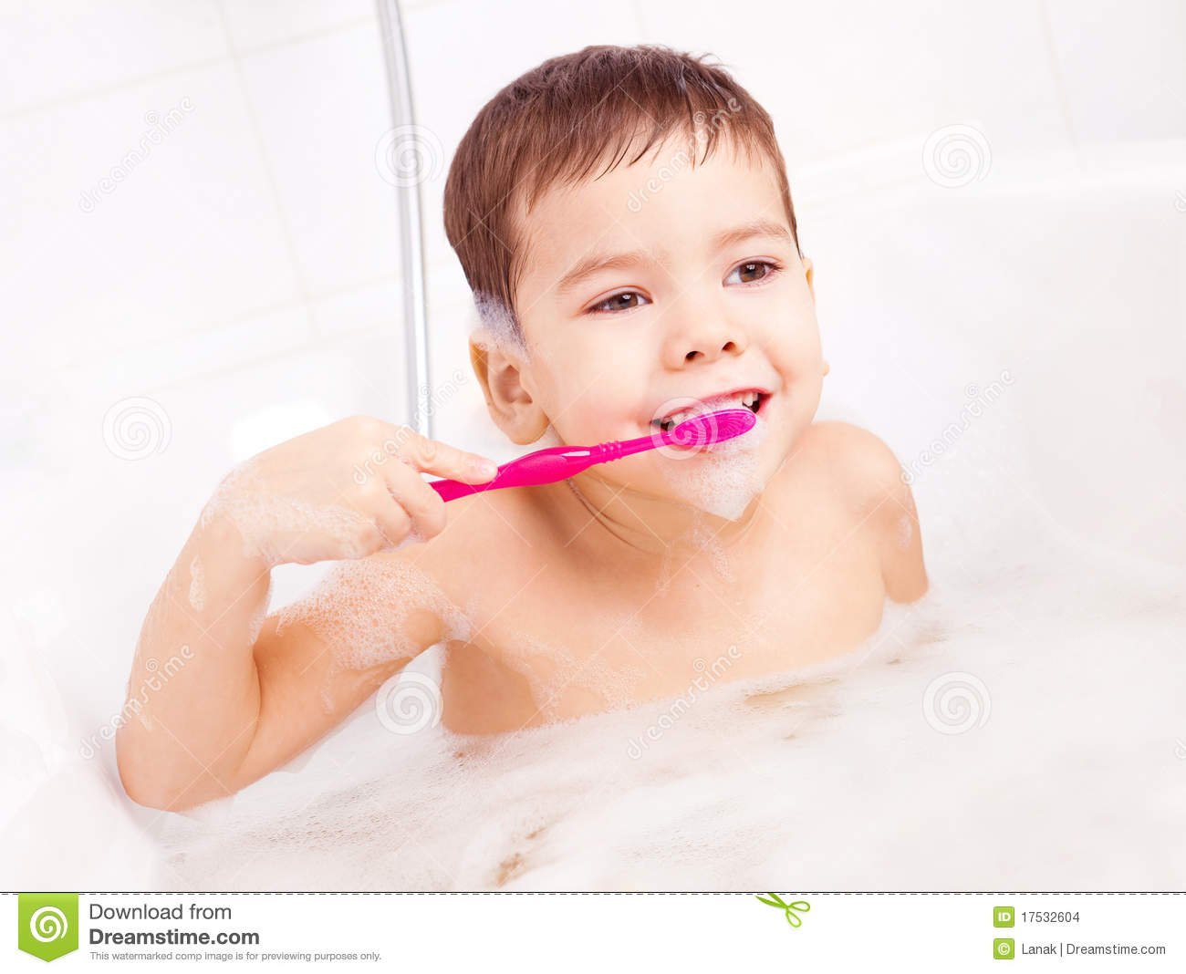 Cute Four Year Old Boy Taking A Bath With Foam And Brushing Teeth 