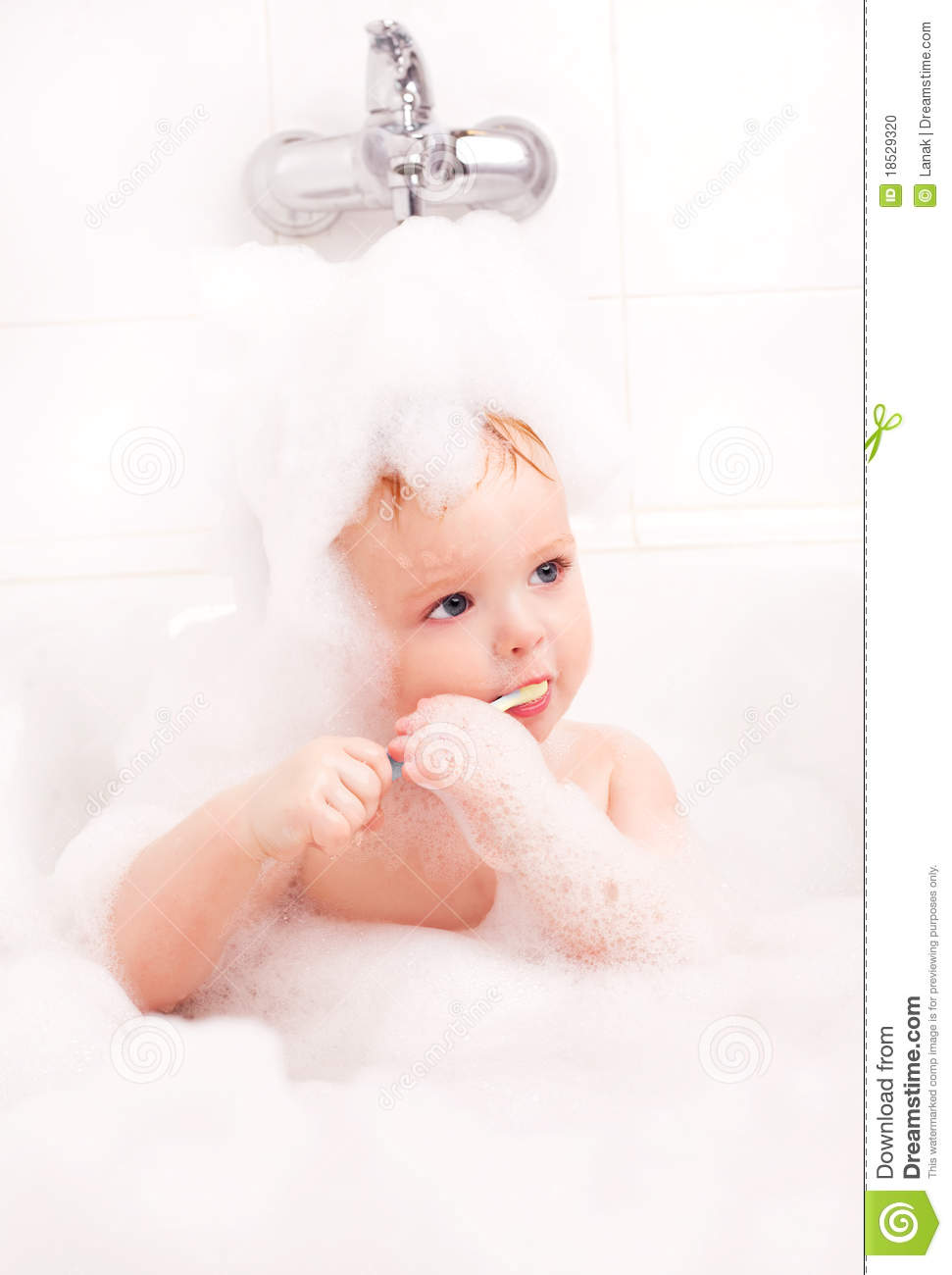 Cute One Year Old Baby Taking A Bath With Foam And Brushing Teeth 