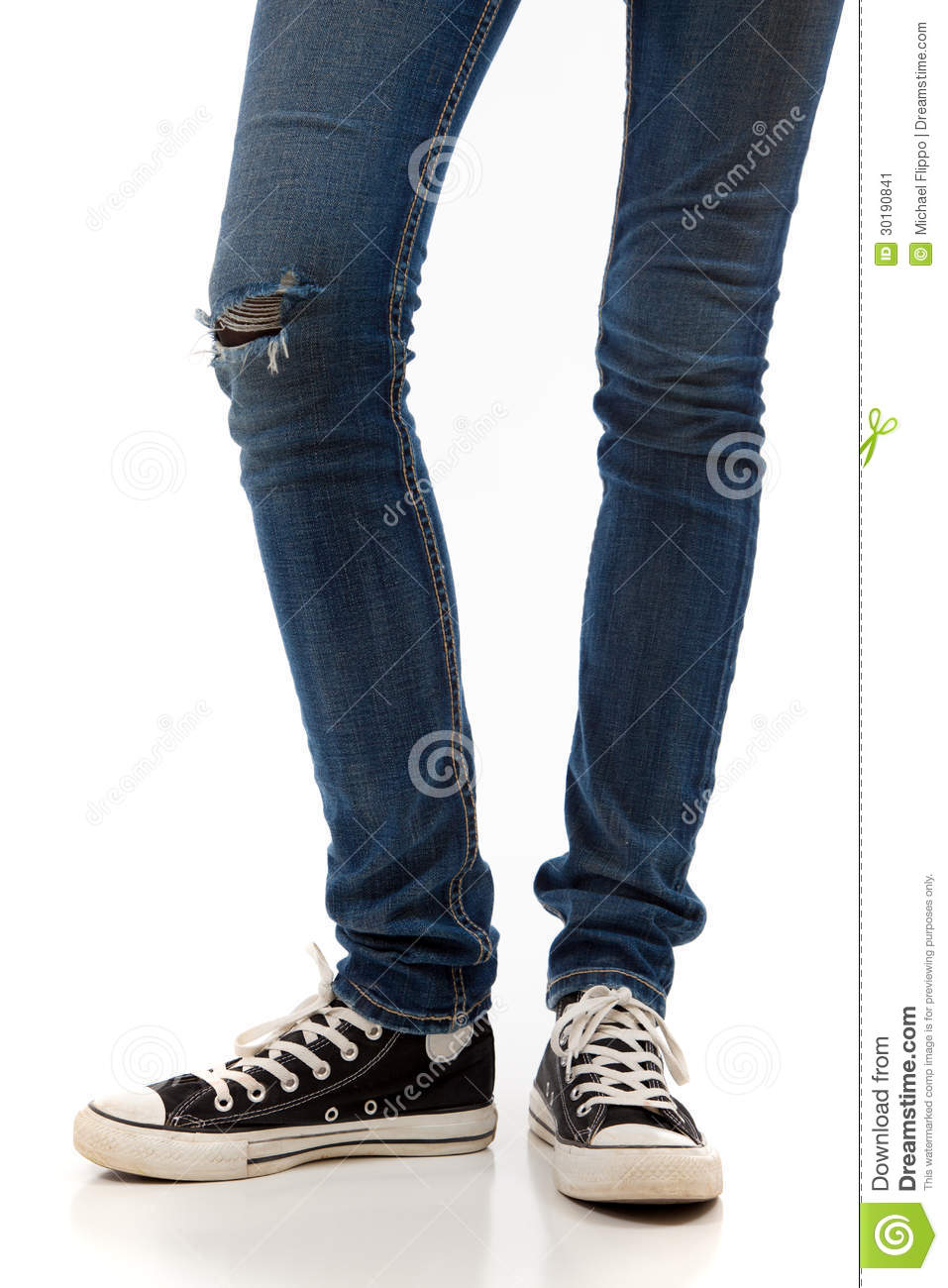 Legs With Jeans And Retro Black Sneakers On A White Background Stock