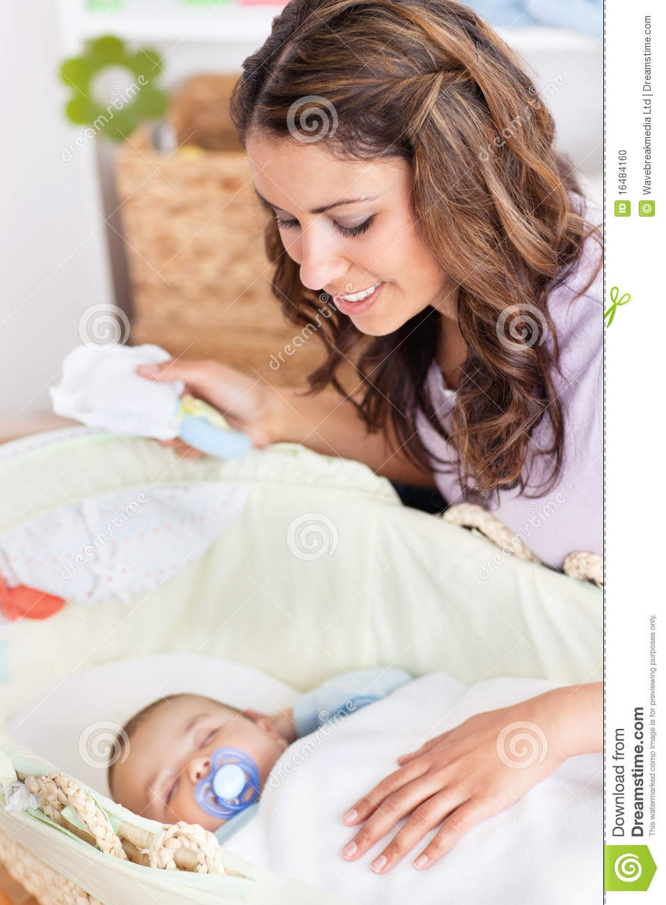 Thoughtful Mother Rocking His Baby Lying Stock Photo   Image  16484160
