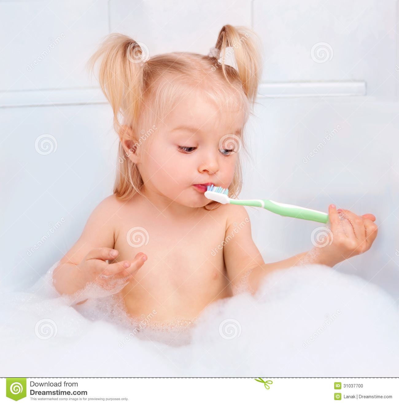 Two Year Old Girl Taking A Bath And Brushing Teeth