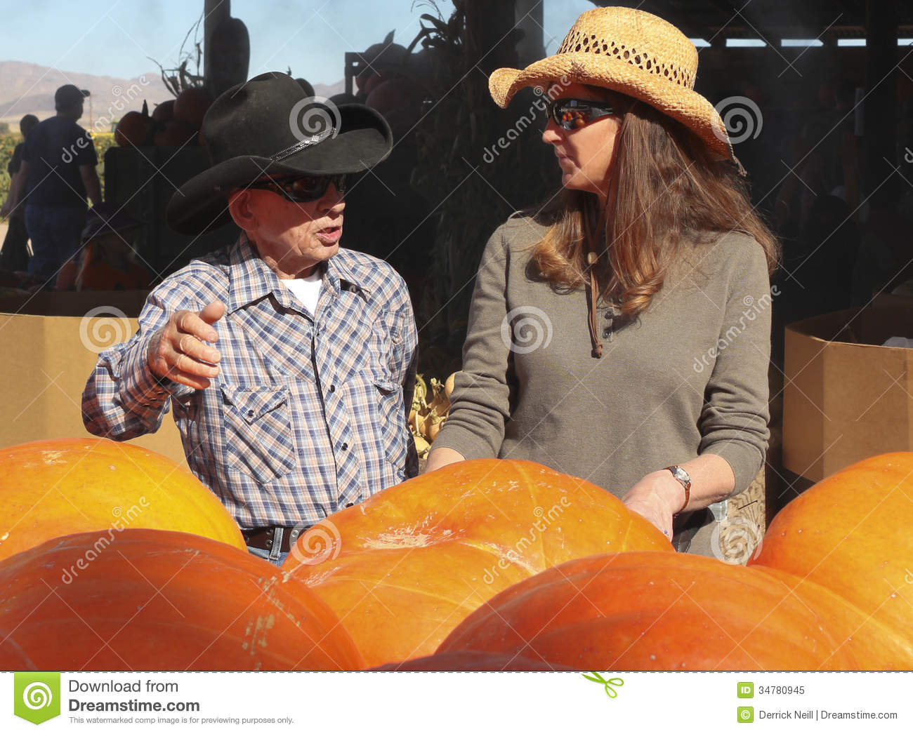 An Old Timer And A Lady Farmer Discuss Produce And Pumpkins At Apple    