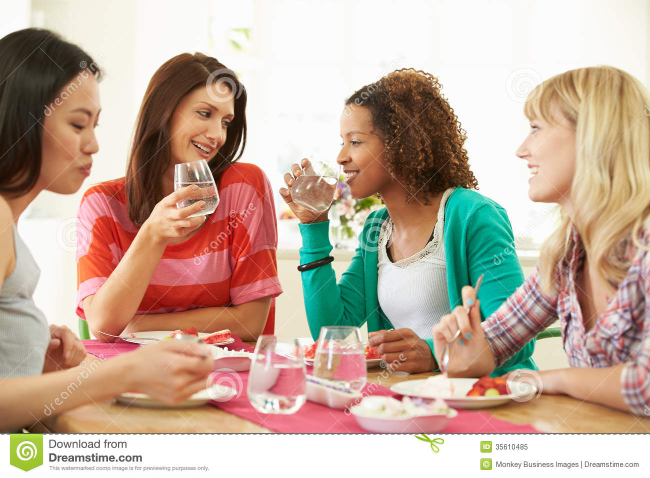 Group Of Women Sitting Around Table Eating Dessert Royalty Free Stock