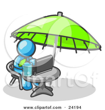     Man Sitting Under An Umbrella At A Table Using A Laptop Computer