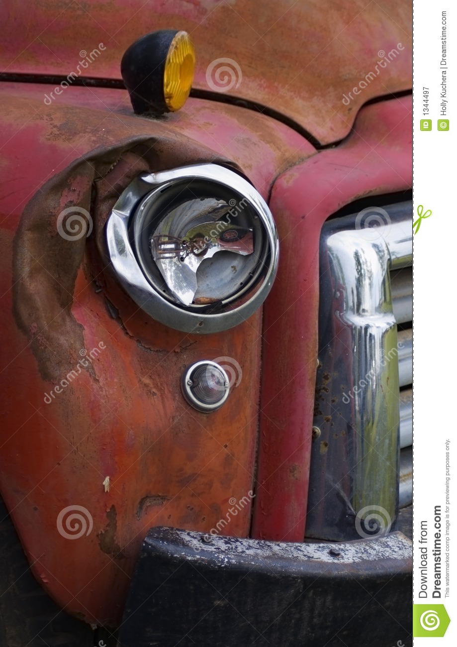Old Red Truck With Broken Headlight And Weathered Paint