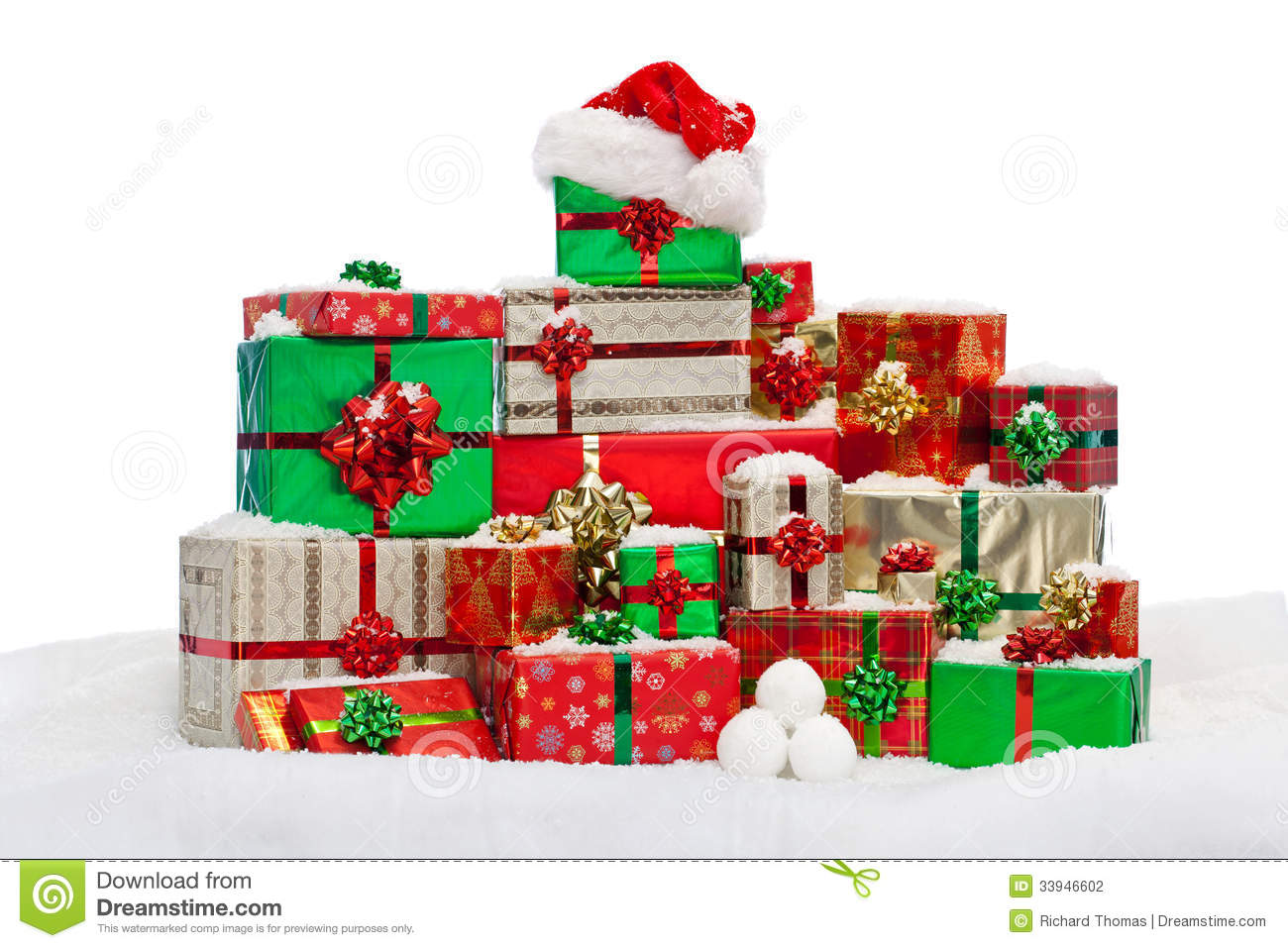 Stack Of Gift Wrapped Christmas Presents On Snow Isolated Against A