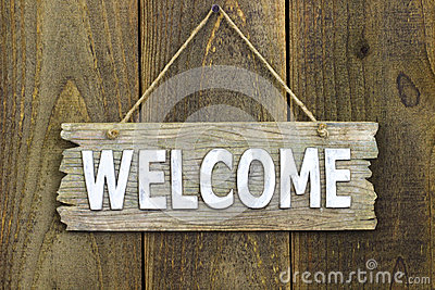 Stock Photo  Wood Welcome Sign Hanging On Rustic Wooden Background