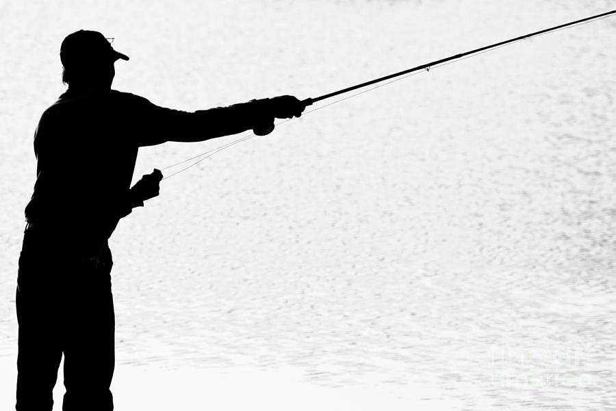 Silhouette Of A Fisherman Holding A Fishing Pole Bw Photograph