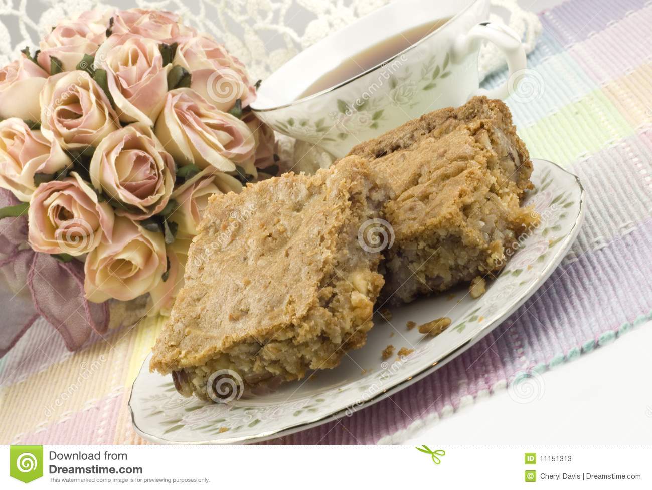 Plate Of Coconut Pecan Blondie Squares And A Cup Of Tea Feminine
