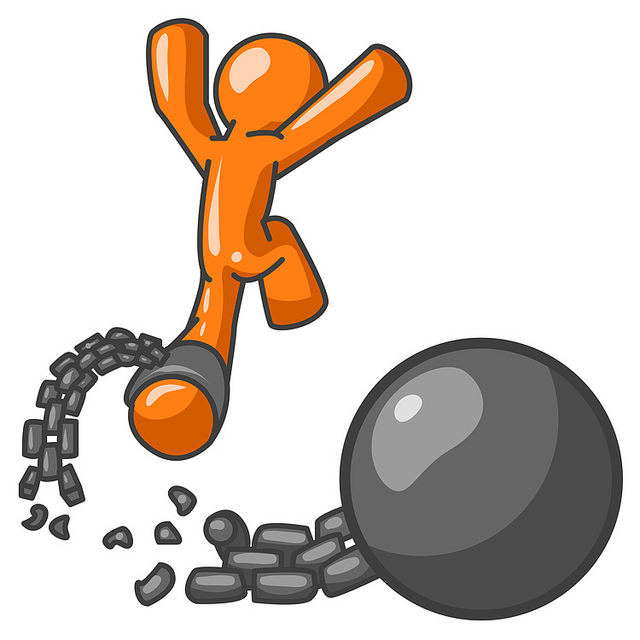 Orange Man Jumping For Joy While Breaking Away From A Ball And Chain