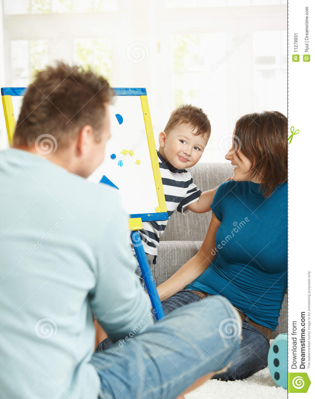 Father Mother And Boy Child Playing Together With Toy Whiteboard