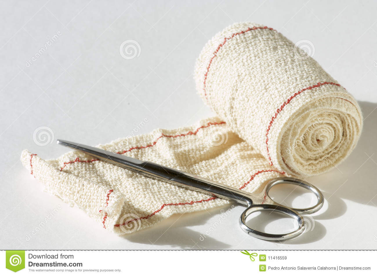 Medical Scissors And Bandages With White Background
