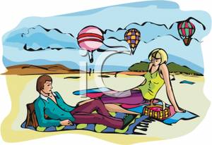 Two People Relaxing On The Beach Near Hot Air Balloons   Royalty Free