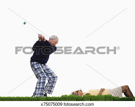 Stock Photograph Of Senior Man Preparing To Hit Golf Ball In Senior