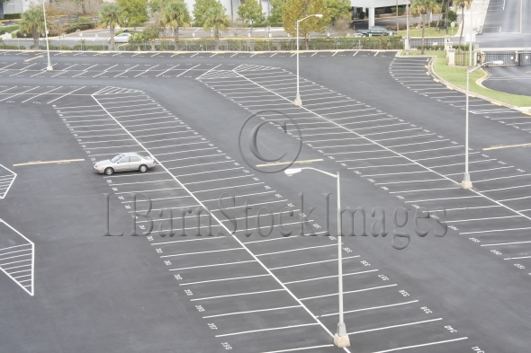 Large Numbered Space Parking Lot With Single Occupant