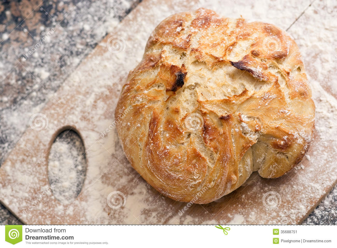 Freshly Baked Artisan Bread On A Marble Background And Cutting Board