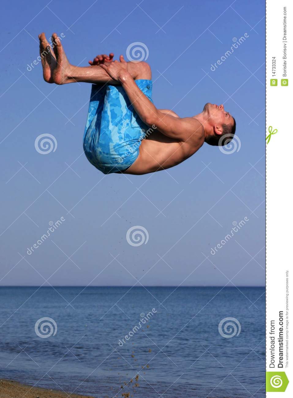 Athletic Man Makes Somersault On The Beach