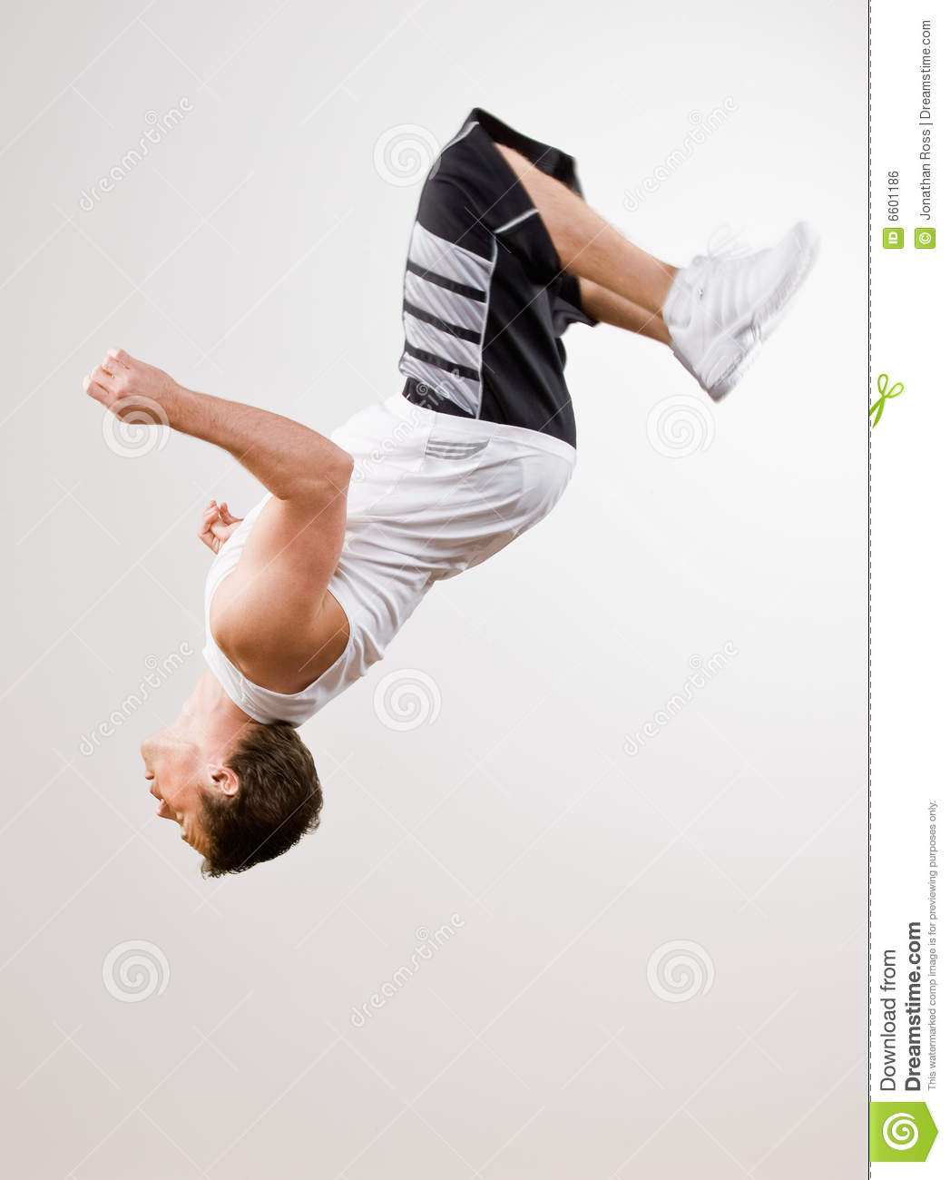 Skilled Athlete Doing Somersault In Mid Air Royalty Free Stock Image