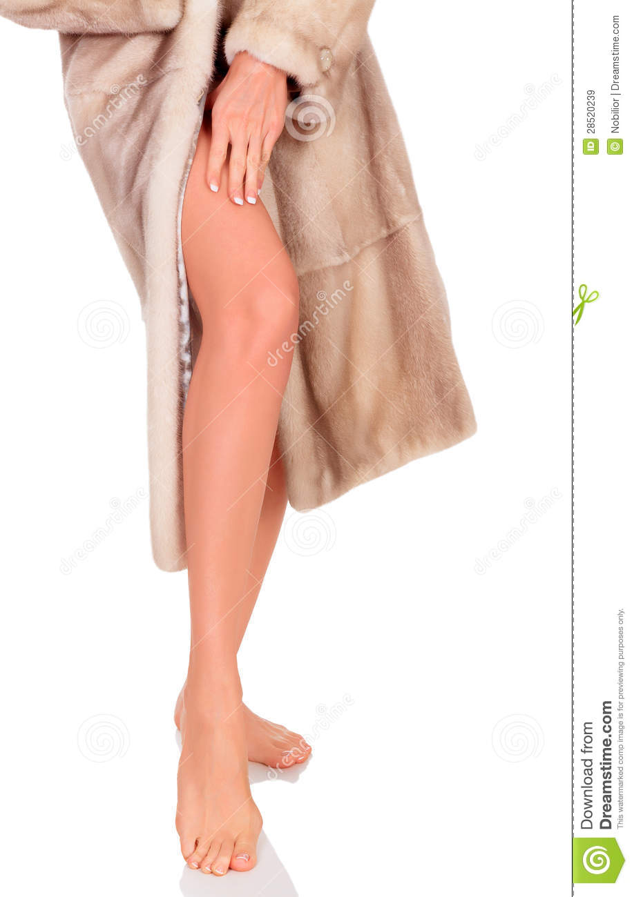 Woman In Fur Coat Showing Her Well Groomed Legs White Background
