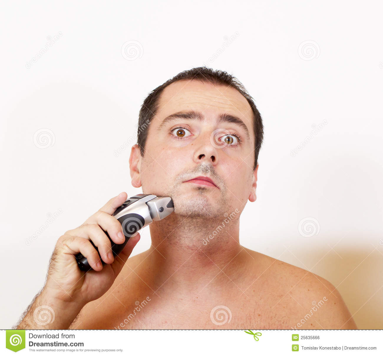 Man Shaving His Beard With An Electric Razor Royalty Free Stock Image